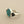 Load image into Gallery viewer, A sterling silver ring featuring a round turquoise stone with brown matrix patterns, set against a dark gray textured background.

