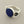 Load image into Gallery viewer, A silver ring featuring a round, dark blue lapis lazuli stone in a bezel setting, photographed on a textured dark gray background.
