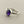 Load image into Gallery viewer, A sterling silver ring featuring an oval cabochon gemstone with a deep purple center and blue edges, resting on a dark gray textured surface.
