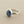 Load image into Gallery viewer, A sterling silver ring featuring a smooth, oval-shaped dark blue cabochon gemstone, displayed on a textured dark gray surface.
