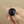 Load image into Gallery viewer, A silver-toned ring featuring a large, faceted black onyx cabochon, photographed on a dark gray textured surface.
