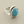 Load image into Gallery viewer, A silver ring featuring a large, oval-cut light blue gemstone in a polished bezel setting, displayed on a dark gray textured surface.

