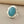 Load image into Gallery viewer, A sterling silver ring featuring an oval-cut turquoise stone, displayed on a dark gray textured surface.
