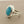 Load image into Gallery viewer, A silver ring featuring a large, smooth, oval-shaped light blue gemstone in a bezel setting, resting on a dark gray textured surface.
