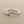 Load image into Gallery viewer, A textured sterling silver ring with a wavy, organic pattern, displayed on a dark gray background.
