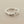 Load image into Gallery viewer, A textured sterling silver ring with an organic, wavy, tree-bark-like band, photographed on a dark gray background.
