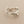 Load image into Gallery viewer, A silver ring with an organic, textured, tree-bark-like shape, photographed on a dark gray background.
