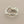 Load image into Gallery viewer, A silver ring with an organic, bark-like textured design, photographed on a dark gray background.

