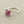 Load image into Gallery viewer, A silver ring featuring a rough, faceted magenta-purple gemstone in a prong setting, displayed on a dark gray textured surface.
