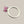 Load image into Gallery viewer, A silver ring featuring a rough-cut pink gemstone in a prong setting, displayed on a dark gray textured background.
