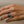 Load image into Gallery viewer, Hand wearing a silver ring on a beige background
