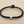 Load image into Gallery viewer, Black braided bracelet with silver beads on a gray background
