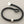 Load image into Gallery viewer, Black bracelet with silver ends on a gray background
