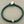 Load image into Gallery viewer, Green bracelet with silver accents on a gray background
