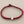 Load image into Gallery viewer, Red braided bracelet with a silver clasp on a gray background
