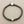 Load image into Gallery viewer, A dark brown braided cord bracelet with a silver-toned coin clasp and a textured silver bead, displayed on a dark gray background.
