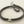 Load image into Gallery viewer, Bracelet with textured brown cord and silver metal ends on a gray background
