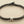 Load image into Gallery viewer, Bracelet with textured brown band and silver accents on a gray background
