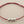 Load image into Gallery viewer, Red bracelet with three silver beads on a gray background
