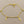 Load image into Gallery viewer, Gold bracelet with musical note charms on a gray background
