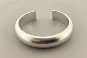Silver bracelet on a gray background