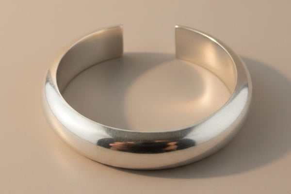 Silver bracelet on a gray background