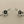 Load image into Gallery viewer, Pair of silver flower-shaped earrings on a gray background
