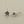 Load image into Gallery viewer, Pair of silver flower-shaped earrings on a gray background

