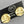Load image into Gallery viewer, A pair of textured gold round stud earrings mounted on a black display card with the brand name 'alan myerson' visible, set against a neutral gray background.
