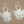 Load image into Gallery viewer, Pair of silver earrings with intricate patterns on a brown background
