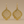 Load image into Gallery viewer, Gold earrings with intricate designs on a beige background
