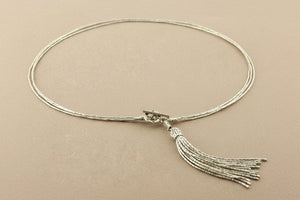 Necklace with tassel on a gray background