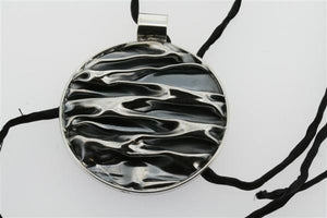 creased circular pendant on black silk - Makers & Providers