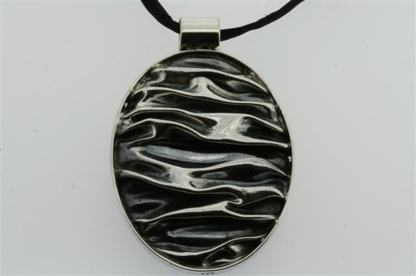 creased oval pendant on black silk - Makers & Providers