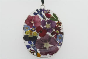 flower/resin pendant - oval on black silk - Makers & Providers