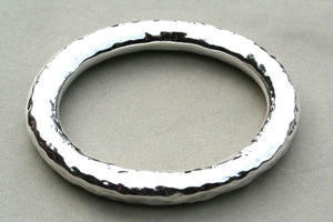 Oval tubular bangle with a hammered treatment - Makers & Providers