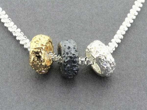 Tubular volcanic pendant - silver, gold & oxidized on 45 cm chain