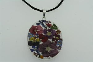 flower/resin pendant - oval on black silk - Makers & Providers