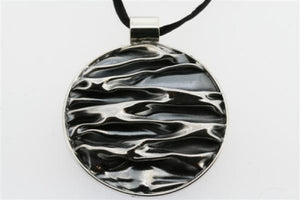 creased circular pendant on black silk - Makers & Providers
