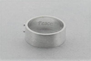 silver braille ring spelling peace
