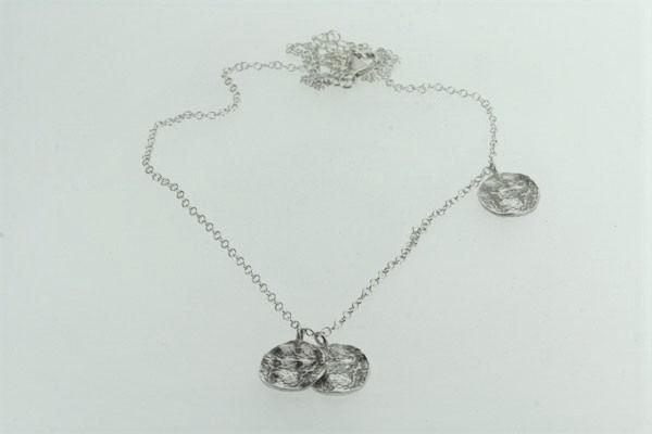 delicate sterling silver necklace with 3 textured discs. Adjustable in size