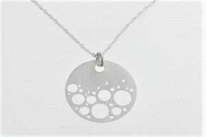 sterling silver circle pendant with bubble cutout detail on silver chain