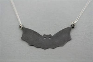 sterling silver bat necklace with an oxidized treatment