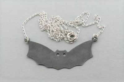 sterling silver bat necklace with an oxidized treatment