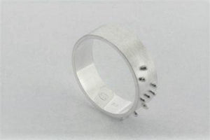 silver ring with braille detail spelling love